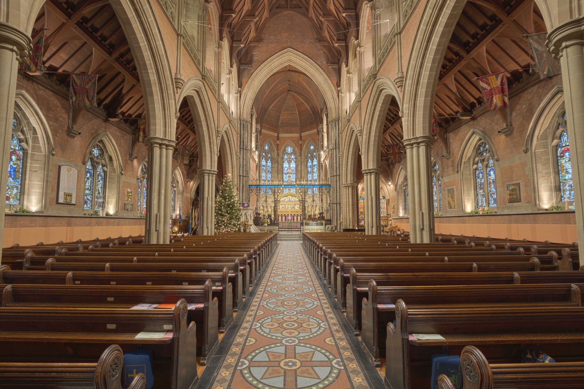 Explore this stunning Gothic church interior in England, showcasing intricate arches and stained glass.